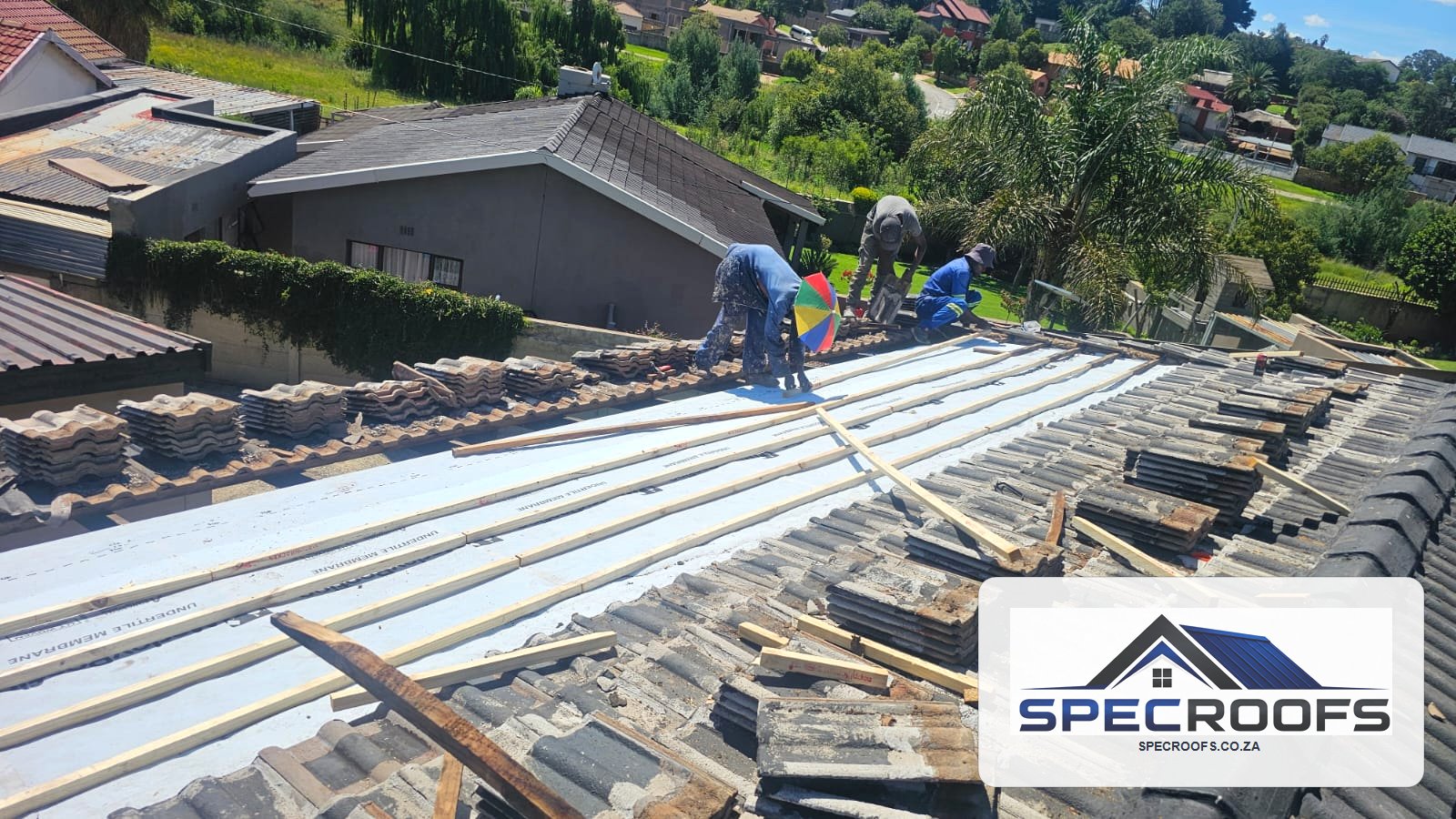Specroofs team preparing a tiled roof replacement